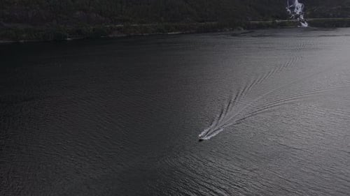 High angle view of Langfossen rushing into a rocky fjord in Norway