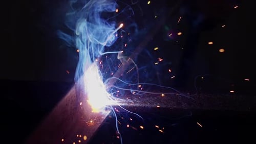 Welding Metal Bar With Sparks and Smoke