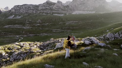 Hikers Navigating Rocky Hillside Path