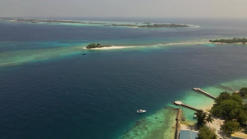 Aerial shot moving over the indian ocean in the maldives