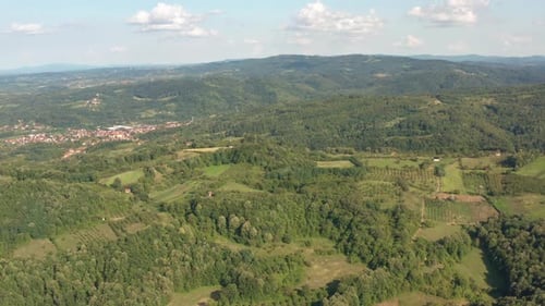 Low flyover amazing green forest on mountains with clouds in background. Spring season in Bosnia and