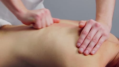 Man Receiving Back Massage From Masseur