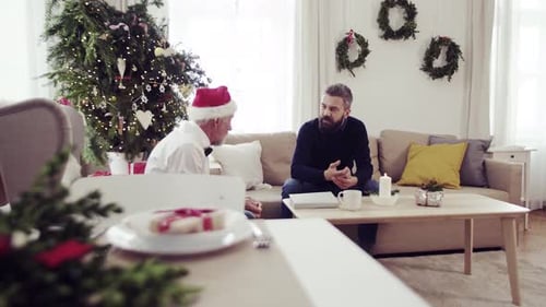 Men Talking Indoors at Christmas Time