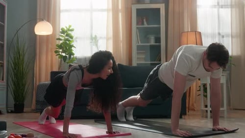 Couple Doing Mountain Climber Exercise at Home Together