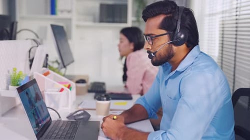 Asian attractive businessman using laptop computer video call in office.