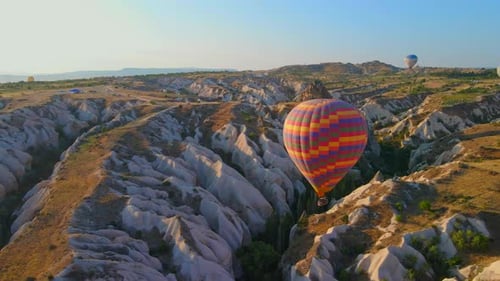 Hot Air Balloons Float Over Cappadocia Desert Landscape