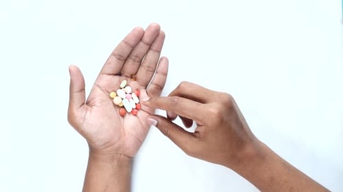 Top View of Men's Hand Taking Medical Pills
