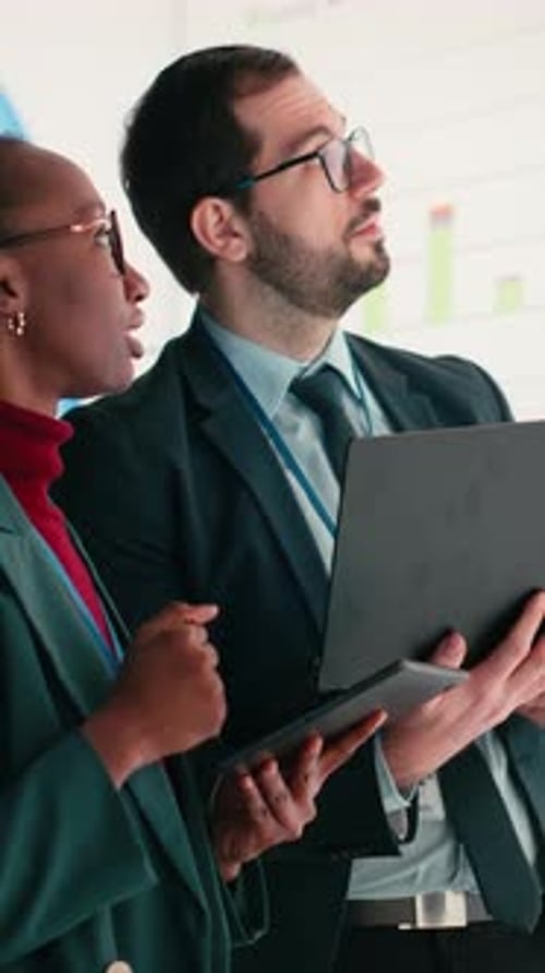 Vertical Video Female Executive and Business Partner Compile Shareholder Financial Report