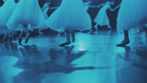 Ballerinas run in a circle on the stage. Close-up of the legs.