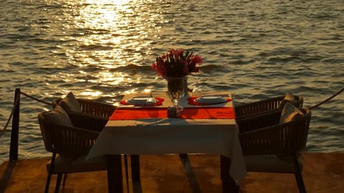 Romantic Dinner Table on Beach at Sunset