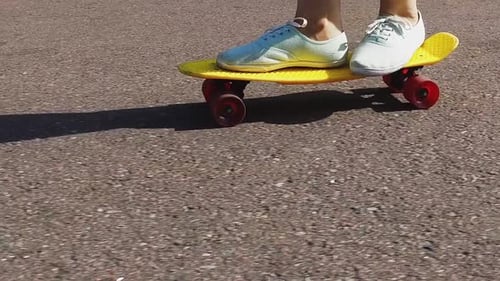 Skateboarding, Leisure, Extreme Sport and People Concept - Teenage Girl Feet Riding
