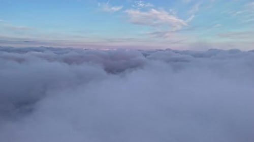 Drone Flight Above Soft, Peaceful Clouds at Sunrise
