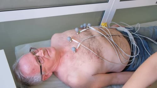 The Doctor Performs Electrocardiography ECG