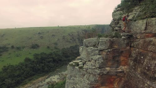 Young free climber conquers mountain cliff at sunset in beautiful South Africa