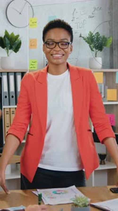 Smiling Woman Standing in Modern Office Setting