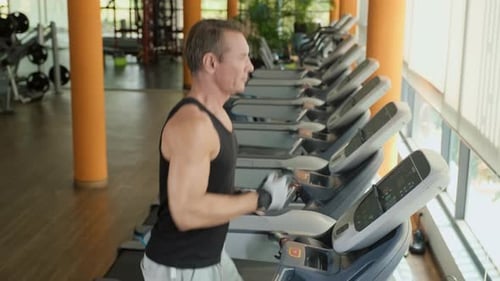 Man Exercising on Treadmill at Gym