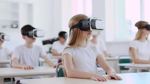 Children Wearing VR Headsets in a Bright Classroom