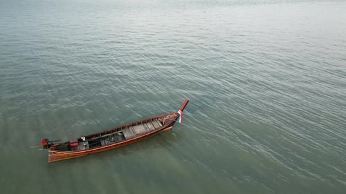 Longtail Boat Floating in Calm Ocean Waters