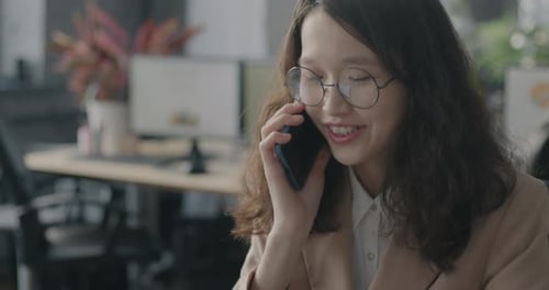Professional Woman Talking on Phone at Office