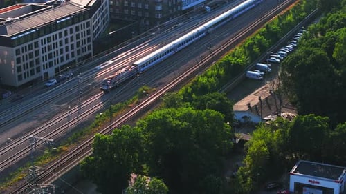 Aerial View of Train Moving Through Urban Landscape