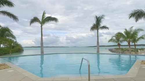 high class swimming pool on oceans edge 4k dolly style