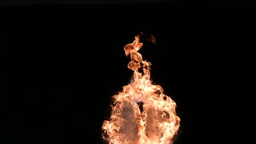 Fire eater performing daring inferno trick in slow motion studio shot