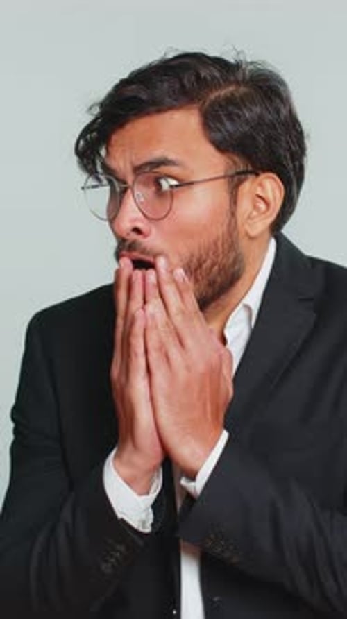 Shocked man wearing glasses looking to the side