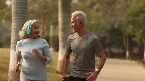 Attractive Couple Enjoying A Joyful Walk in the Park During Sunset