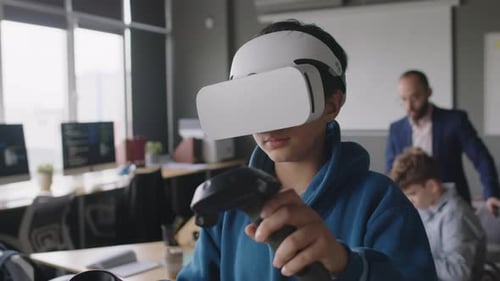 Young Boy in AR Headset Manipulating Virtual Objects at Programming Club