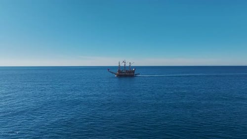 Aerial Video Pirate Ship Moving Across The Blue Sea Toward A Historic Port A Beautiful Nautical