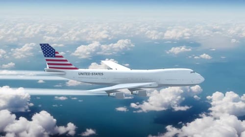 United States Commercial Airplane Flying Across Sky Through Clouds