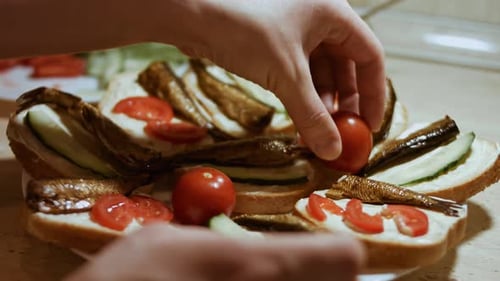 Person Preparing Open Faced Sandwiches at Home