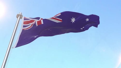 Waving Australian Flag Against Clear Blue Sky