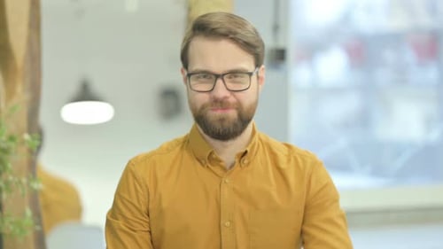 Adult Man Points Finger Toward Camera Indoors