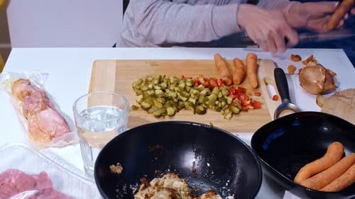 Timelapse slow zoom of woman chopping carrots and pickles for home soup prep