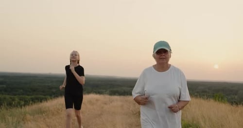 An Active Senior Woman on a Run Her Granddaughter Catches Up