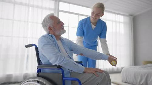 Senior Man Exercising with Nurse in Bright Room