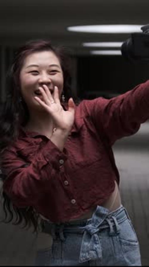 Smiling Woman Recording Video With Camera