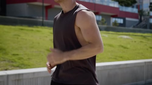 Young Adult Man Jogging Outdoors in Urban Setting
