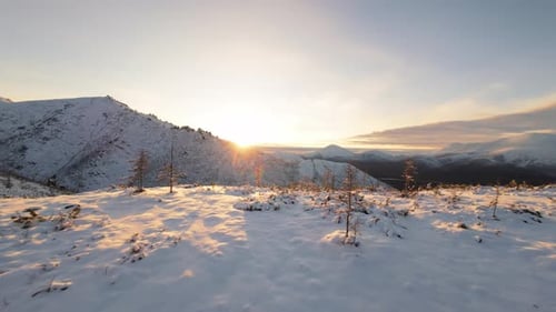 Snowy Mountains at Sunrise in Golden Light