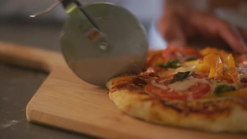 Cutting Pizza Into Slices. Close Up