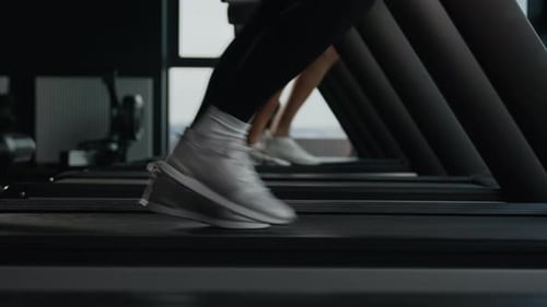 Close Up Sport Shoes Sneakers Female Male Legs Feet Motion Run Jog on Treadmill Workout in Gym