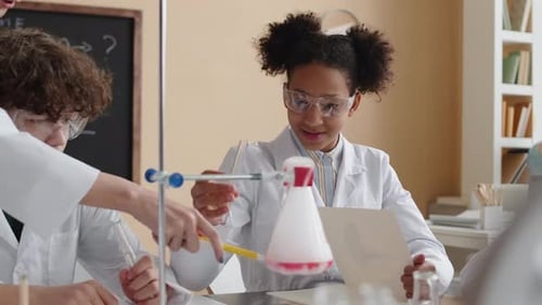Students Performing Science Experiment in Classroom