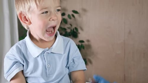 Little Boy Receives Medicine from Medical Professional