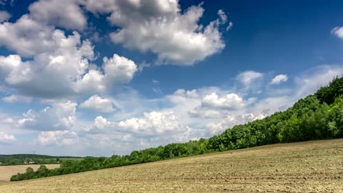Picturesque Countryside with Field, Sky, and Clouds