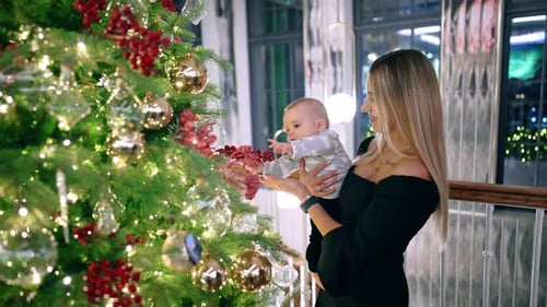 Family with Baby Decorating Christmas Tree Together