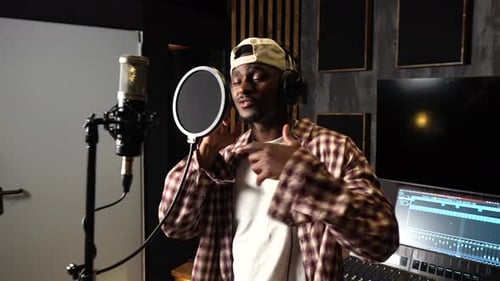 Young talented african american artist recording new album in professional studio
