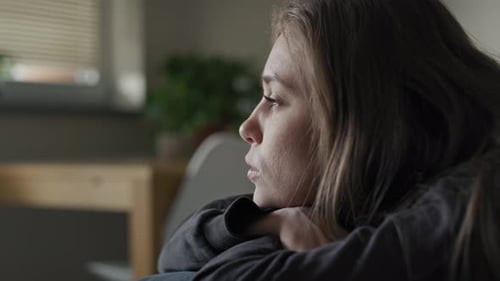 Caucasian young woman looking away with depression. Shot with RED helium camera in 8K.