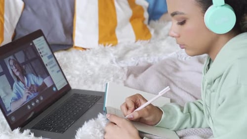 Teen Girl Studying With Laptop in Bedroom