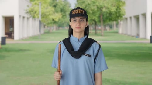 Indian female security guard standing on duty